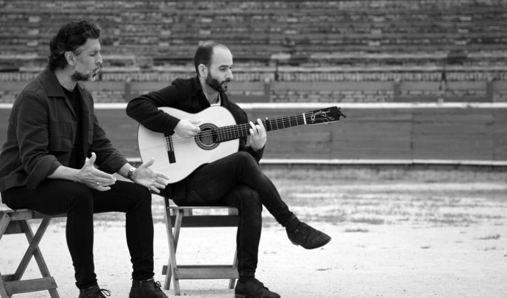 dos hombres tocando la guitarra